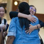From left, Janet Grier, assistant professor of education, Crystal Wang, Crystal Toombs, associate provost of adult & graduate studies and Daisy Qiu greet each other in the airport after the student's flight.