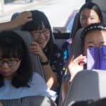 Clockwise from bottom left, Lynn Lu, Lavender Qin, Iris Shi, Cathy Wu ride the bus through Atlanta.