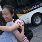 Crystal Wang hugs Jordan Anderson, director of international students & programs, after arriving on Brenau's Historic Gainesville Campus.
