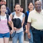From left, Crystal Wang, Cathy Wu, Daisy Qiu and College of Education Dean Eugene Williams walk into the arrivals area at Hartsfield-Jackson International Airport in Atlanta.