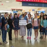 From left, Harry Deng, Daisy Qiu, Janet Grier, Lavender Qin, Crystal Toombs, Cathy Wu, Crystal Wang, Iris Shi, Lynn Lu and Eugene Williams pose for a photo at Hartsfield-Jackson International airport.