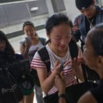 Crystal Wang receives a bag of Brenau themed items from Janet Grier before boarding the bus from the airport.