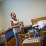 Cathy Wu, center, smiles inside her room inside the New Hall student residence while talking with Jordan Anderson, right, and Amanda Buchanan.