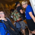 Annie Johnston, director of freshman admissions, hugs Daisy Qiu as Amanda Lammers, Vice President of Student Services, looks on.