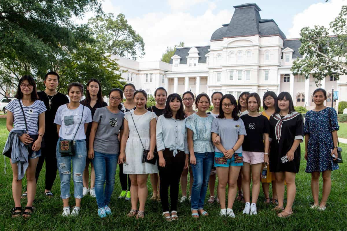 Front row from left to right, Jocelyn Heng, Miao Miao Yu, Alice Han, Lily Li, Lynn Lu, Belle Ni, Rachel Pei, Cherry Hong, Lavender Qin, Daisy Qiu and back row from left to right, Harry Deng, Iris Shi, Amy Yang, Cathy Wu, Skye Qi, Crystal Wang, Lisa Wang and Becky Xu pose for a group portrait on the front lawn of Brenau's Historic Gainesville Campus.