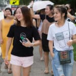 From left to right, Becky Xu, Cherry Hong, Cathy Wu and Miao Miao Yu walk along the sidewalk on Washington Street on Brenau's Historic Gainesville Campus.