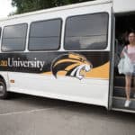 Skye Qi gets off the bus after taking a shopping trip to Walmart.