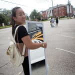 Cathy Wu holds a mirror she bought on her first shopping trip to Walmart.