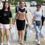 From left to right, Cherry Hong, Cathy Wu and Miao Miao Yu carry supplies back to their residence halls.