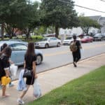 Two plus two students make their way to their residence halls after a shopping trip.