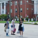 Alice Han, Jocelyn Heng and Iris Shi carry purchases to their residences after a shopping trip.